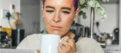 Woman drinking from a white mug