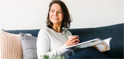 Woman sitting on a sofa with a mug